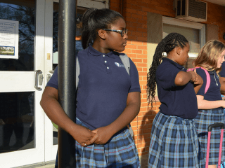 Girls waiting in front on Serviam Academy